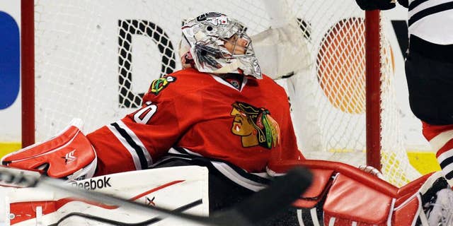 Chicago Blackhawks goalie Corey Crawford (50) reacts after Minnesota Wild's Erik Haula (56) scored his goal during the first period  in Game 5 of an NHL hockey second-round playoff series in Chicago,Sunday, May 11, 2014. (AP Photo/Nam Y. Huh)