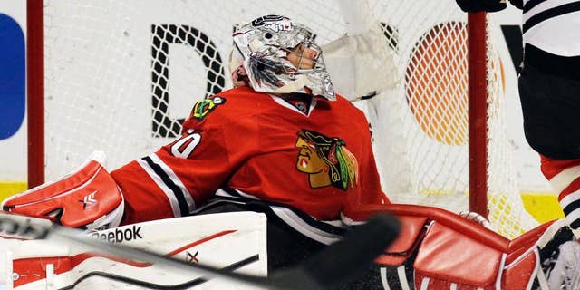 Chicago Blackhawks goalie Corey Crawford (50) reacts after Minnesota Wild's Erik Haula (56) scored his goal during the first period in Game 5 of an NHL hockey second-round playoff series in Chicago,Sunday, May 11, 2014. (AP Photo/Nam Y. Huh)