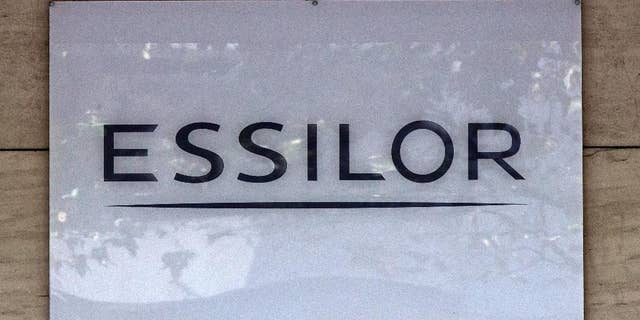 This Thursday, Sept. 22, 2016 photo shows the logo of the Essilor a French ophthalmic optics company, in Charenton le Pont, east of Paris. Essilor International SA announced Monday Jan.16, 2017 it had reached a share exchange deal with Luxottica's main shareholder Delfin to create a combined company making both frames and lenses. (AP Photo/Michel Euler)