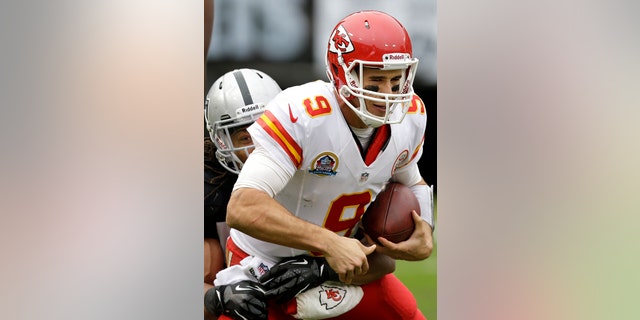 FILE - In this Dec. 16, 2012, file photo, Kansas City Chiefs quarterback Brady Quinn (9) is sacked by Oakland Raiders linebacker Philip Wheeler during the second quarter of an NFL football game in Oakland, Calif. Quinn is the new backup quarterback for the Seattle Seahawks after agreeing to terms with the club. The deal was announced by the team on Tuesday, April 9, 2013. (AP Photo/Marcio Jose Sanchez, File)