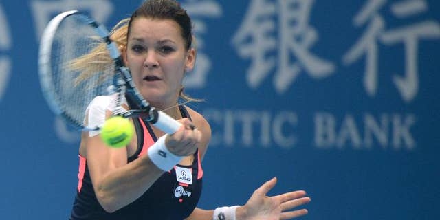 Agnieszka Radwanska of Poland returns to Stefanie Voegele of Switzerland during their women's single match at the China Open tennis tournament in Beijing on September 29, 2013
