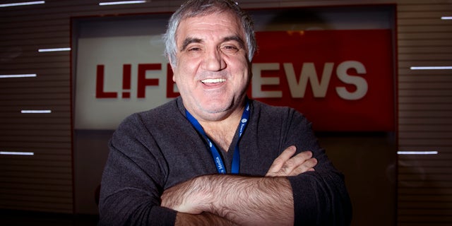 Aram Gabrelyanov, Lifenews owner, smiles during the interview to The Associated Press in the company headquarters in Moscow on Monday, Oct. 14, 2013. Now the Gabrelyanovs’ company, News Media Holding, earns $1.5 billion per year. In addition to Life, they own Izvestia, once the official newspaper of the Soviet government, as well as two tabloids and three websites. The younger son and inheritor of the empire, 24-year-old Ashot, runs Lifenews.ru as well as a new TV station. There is no substantive division between the holding’s publications, which freely feed one another information and scoops, which are then retailored for each audience. The elder son, 26-year-old Artem, directs their comic book line, with a host of Russified superheroes that includes an Orthodox priest. (AP Photo/Ivan Sekretarev)