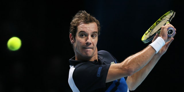 Richard Gasquet of France plays a return to Novak Djokovic of Serbia during their ATP World Tour Finals tennis match at the O2 Arena in London, Saturday, Nov. 9, 2013. (AP Photo/Alastair Grant)