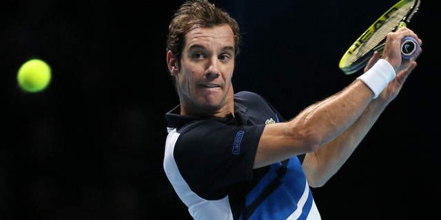 Richard Gasquet of France plays a return to Novak Djokovic of Serbia during their ATP World Tour Finals tennis match at the O2 Arena in London, Saturday, Nov. 9, 2013. (AP Photo/Alastair Grant)