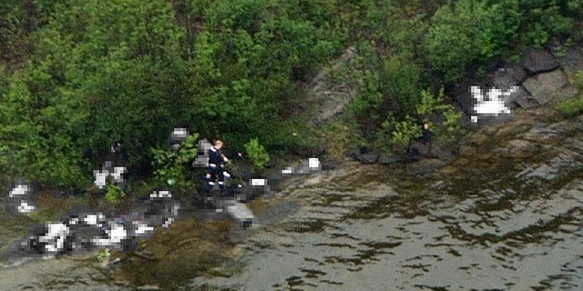July 22: This photo taken from a helicopter above Utoya island near Oslo, Norway, shows what police believe is the alleged gunman walking among victims after opening fire on a youth retreat.