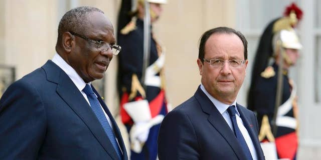 France President Francois Hollande (right) accompanies his Malian counterpart Ibrahim Boubacar at the Elysee palace in Paris on October 1st, 2013