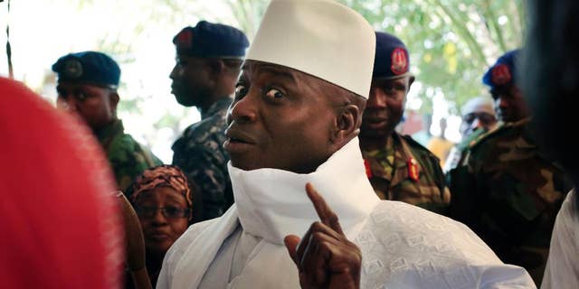 FILE- In this Thursday, Dec. 1, 2016 file photo, Gambia's president Yahya Jammeh shows his inked finger before voting in Banjul, Gambia. President Yahya Jammeh, who at first surprised Gambians by conceding defeat after 22 years in power, a week later announced that he had changed his mind. He alleges voting irregularities that make the Dec. 1 ballot invalid. (AP Photo/Jerome Delay, File)