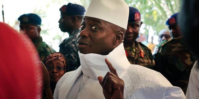 FILE- In this Thursday, Dec. 1, 2016 file photo, Gambia's president Yahya Jammeh shows his inked finger before voting in Banjul, Gambia. President Yahya Jammeh, who at first surprised Gambians by conceding defeat after 22 years in power, a week later announced that he had changed his mind. He alleges voting irregularities that make the Dec. 1 ballot invalid. (AP Photo/Jerome Delay, File)