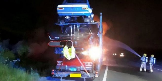 A transporter carrying a dozen novelty cars including a BATMOBILE caught fire - burning a number of vintage vehicle to bits. See SWNS story SWFIRE; The lorry was travelling westbound on the M4 near Bath on Wednesday night when it went up in flames. Highways England was forced to shut two lanes of the motorway as firefighters battled the blaze into the early hours of Thursday. It is not know the extent of damage the cars suffered, but Highways England said a number of the specialists cars along with the transporter cab had been destroyed. The truck had been transporting a number of classic cars including a âDukes of Hazzardâ General Lee, Batmobile, âTransformersâ Ford Mustang and âStarsky and Hutchâ Ford Torino.