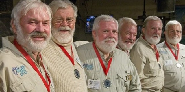 In this photo, released by the Florida Keys News Bureau, some of the semi-finalists of the 2011 "Papa" Hemingway Look-Alike Contest including, from left, Arnie Inge-Mathisen, Bear Hoochuck, Greg Fawcett, Charlie Boice, Ed Lindoo and Frank Long show their to looks to the audience during the first of two preliminary rounds Thursday, July 21, 2011, at Sloppy Joe's Bar in Key West, Fla. More than 120 men resembling Ernest Hemingway are entered into the contest that is a facet of Key West's annual Hemingway Days festival. The finals are set for Saturday, July 23.