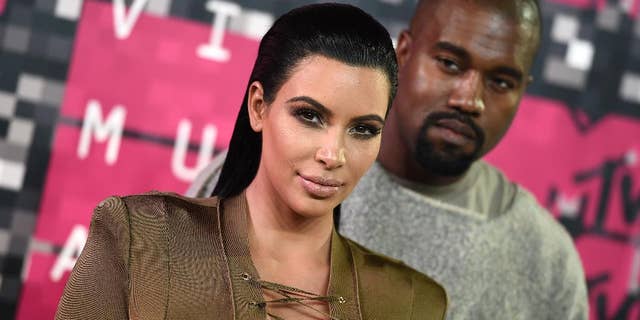 FILE - In this Aug. 30, 2015, file photo, Kim Kardashian, left, and Kanye West arrive at the MTV Video Music Awards at the Microsoft Theater in Los Angeles. Kardashian praised her husband's May 19, 2016, appearance on "The Ellen DeGeneres Show" on Twitter. (Photo by Jordan Strauss/Invision/AP, File)