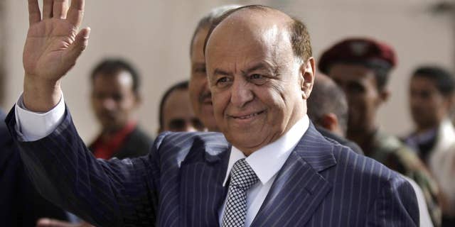 FILE - In this Tuesday, Feb. 21, 2012 file photo,Yemen's Vice President Abed Rabbo Mansour Hadi gestures as he enters a polling center to cast his vote in Sanaa. Yemen's embattled president fled his palace in Aden for an undisclosed location Wednesday as Shiite rebels offered cash bounty for his capture and arrested his defense minister. Hadi left just hours after the rebels' own television station said they seized an air base where U.S. troops and Europeans advised the country in its fight against al-Qaida militants. (AP Photo/Hani Mohammed, File)