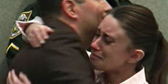 July 5: Casey Anthony hugs her attorney, Jose Baez, after hearing a jury clear her of killing her 2-year-old daughter, Caylee.