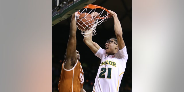 Baylor's Isaiah Austin (21) scores over Texas' Jonathan Holmes during the second half of a NCAA college basketball game, Saturday, Jan. 5, 2013, in Waco, Texas. Baylor won in overtime 86-79. (AP Photo/Waco Tribune Herald, Rod Aydelotte)