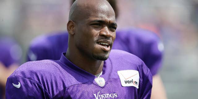 FILE - This July 31, 2014, file photo shows Minnesota Vikings running back Adrian Peterson during NFL football training camp in Mankato, Minn. The NFL suspended Adrian Peterson without pay for at least the remainder of the season. The league said Tuesday, Nov. 18, 2014, it informed the Minnesota Vikings running back he will not be considered for reinstatement before April 15 for violating the NFL personal conduct policy. (AP Photo/Charlie Neibergall, File)