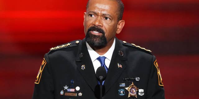 FILE- In this July 18, 2016, file photo, David Clarke, Sheriff of Milwaukee County, Wis., speaks during the opening day of the Republican National Convention in Cleveland. A jury on Monday, May 1, 2017, recommended criminal charges against seven Milwaukee County jail staffers in the dehydration death of an inmate who went without water for seven days. The jail is overseen by Clarke, but the inquest did not target him. (AP Photo/J. Scott Applewhite, File)