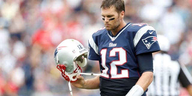 Sep 21, 2014; Foxborough, MA, USA; New England Patriots quarterback Tom Brady (12) reacts to a failed pass attempt during the fourth quarter against Oakland Raiders at Gillette Stadium. The New England Patriots won 16-9. Mandatory Credit: Greg M. Cooper-USA TODAY Sports