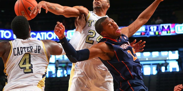020313 ATLANTA: Georgia Tech forward Kammeon Holsey, center, and Virginia forward Akil Mitchell battle for a rebound during the first half of their NCAA college basketball game Sunday Feb. 3, 2013, in Atlanta. (AP Photo/Atlanta Journal-Constitution, Curtis Compton) MARIETTA DAILY OUT; GWINNETT DAILY POST OUT; LOCAL TV OUT; WXIA-TV OUT; WGCL-TV OUT MBI (REV-SHARE)