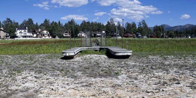 FILE - This Aug. 24, 2015, file photo, shows a boat dock by the lake bed where water has dried due to the drought at Big Bear Lake, Calif.