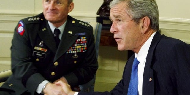 Army General Dan McNeill meets with President George W. Bush in the Oval Office at the White House. General McNeill was U.S. Commander in Afghanistan from May 2002 until May 2003 and from February 2007 until June 2008. He was in charge of more than 10,000 troops in 2003 and 30,000 in 2008.