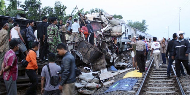 Oct. 2: Rescuers search for victims of a train crash near a station in Petarukan, Indonesia. The early morning train crash killed at least 36 and injured dozens, many of critically, officials and witnesses said.