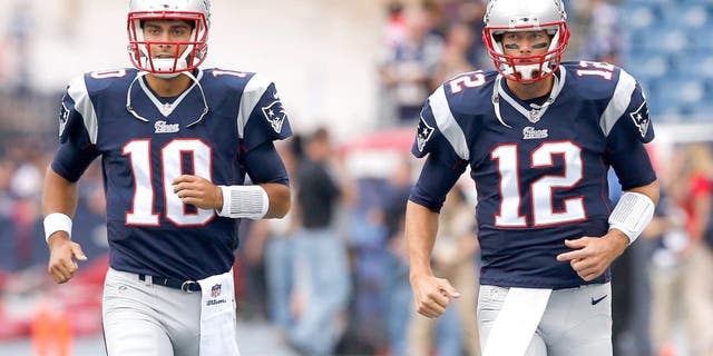 FOXBORO, MA - SEPTEMBER 21: Jimmy Garoppolo #10 and Tom Brady #12 of the New England Patriots warm up during pre-game before playing the Oakland Raiders at Gillette Stadium on September 21, 2014 in Foxboro, Massachusetts. (Photo by Jim Rogash/Getty Images)