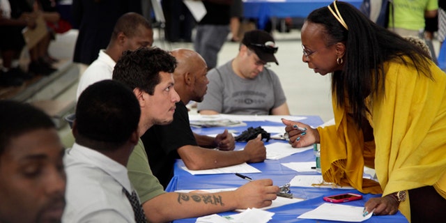 Aug. 21, 2012: Job seekers fill out applications at a construction job fair in New York.
