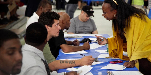 Aug. 21, 2012: Job seekers fill out applications at a construction job fair in New York.