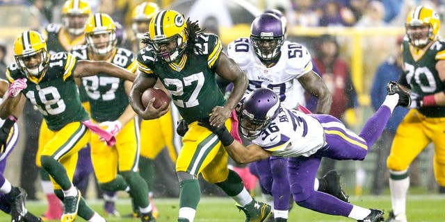 GREEN BAY, WI - OCTOBER 2: Eddie Lacy #27 of the Green Bay Packers carries the football against Robert Blanton #36 of the Minnesota Vikings in the first half of the NFL game on October 02, 2014 at Lambeau Field in Green Bay, Wisconsin. (Photo by John Konstantaras/Getty Images)