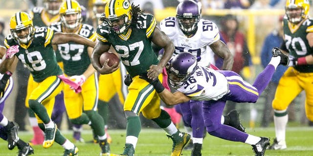GREEN BAY, WI - OCTOBER 2: Eddie Lacy #27 of the Green Bay Packers carries the football against Robert Blanton #36 of the Minnesota Vikings in the first half of the NFL game on October 02, 2014 at Lambeau Field in Green Bay, Wisconsin. (Photo by John Konstantaras/Getty Images)