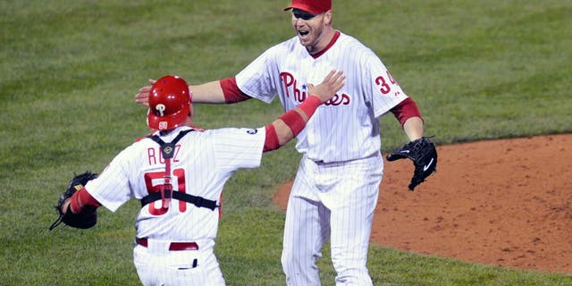 PHILADELPHIA - OCTOBER 06: Roy Halladay #34 of the Philadelphia Phillies celebrates with Carlos Ruiz #51 after throwing a no hitter against the Cincinnati Reds on October 6, 2010 during Game 1 of the NLDS at Citizens Bank Park in Philadelphia, Pennsylvania. The Phillies defeated the Reds 4-0. (Photo by: Rob Tringali/SportsChrome/Getty Images) *** Local Caption *** Roy Halladay;Carlos Ruiz