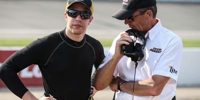 Brad Keselowski, driver of the #2 Miller Lite Ford, stands on the grid during practice for the NASCAR Sprint Cup Series Pure Michigan 400 at Michigan International Speedway on August 14, 2015 in Brooklyn, Michigan.