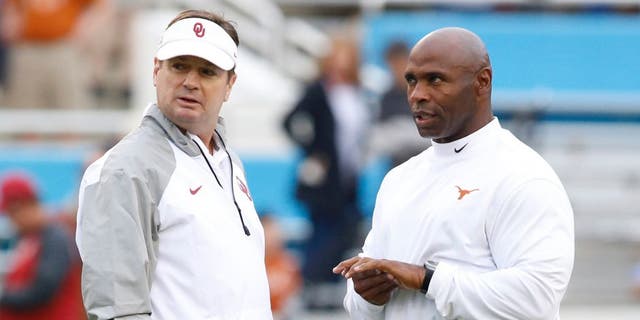 Oct 11, 2014; Dallas, TX, USA; Oklahoma Sooners head coach Bob Stoops (L) talks with Texas Longhorns head coach Charlie Strong before the game at the Cotton Bowl. Mandatory Credit: Tim Heitman-USA TODAY Sports