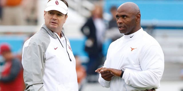 Oct 11, 2014; Dallas, TX, USA; Oklahoma Sooners head coach Bob Stoops (L) talks with Texas Longhorns head coach Charlie Strong before the game at the Cotton Bowl. Mandatory Credit: Tim Heitman-USA TODAY Sports