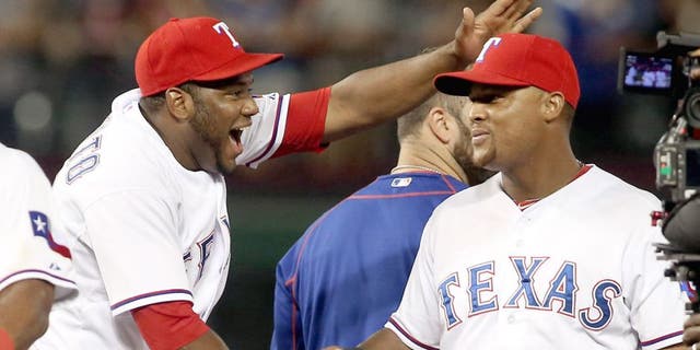 The Texas Rangers' Hanser Alberto, left, pats Adrian Beltre on the head as they celebrate a 5-3 win against the Los Angeles Angels at Globe Life Park in Arlington, Texas, on Thursday, Oct. 1, 2015. (Richard W. Rodriguez/Fort Worth Star-Telegram/TNS via Getty Images)