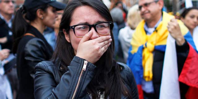 Oct. 2, 2016: A supporter of the peace accord signed between the Colombian government and rebels of the Revolutionary Armed Forces of Colombia, FARC, cries as she follows on a giant screen the results of a referendum to decide whether or not to support the deal in Bogota, Colombia,.