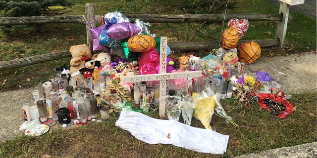 In this Sept. 27, 2016 photo, a memorial for Nisa Mickens and Kayla Cueva is located near the locations where their bodies were found in Brentwood, N.Y.