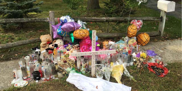 In this Sept. 27, 2016 photo, a memorial for Nisa Mickens and Kayla Cueva is located near the locations where their bodies were found in Brentwood, N.Y.