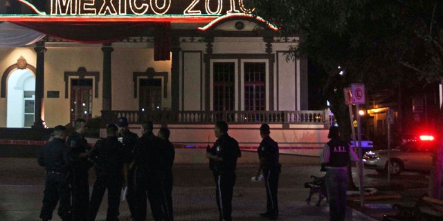Oct. 2: Police officers stand at the area where a grenade was detonated by unidentified people, leaving at least 15 people injured, in front of the town hall in the municipality of Guadalupe, outskirts of Monterrey, northern Mexico.