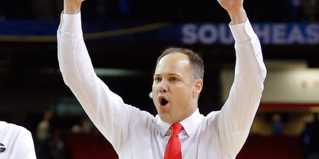 Mar 14, 2014; Atlanta, GA, USA; Georgia Bulldogs forward Cameron Forte (11) and head coach Mark Fox celebrate defeating the Mississippi Rebels in the quarterfinals of the SEC college basketball tournament at Georgia Dome. Georgia won 75-73. Mandatory Credit: Paul Abell-USA TODAY Sports