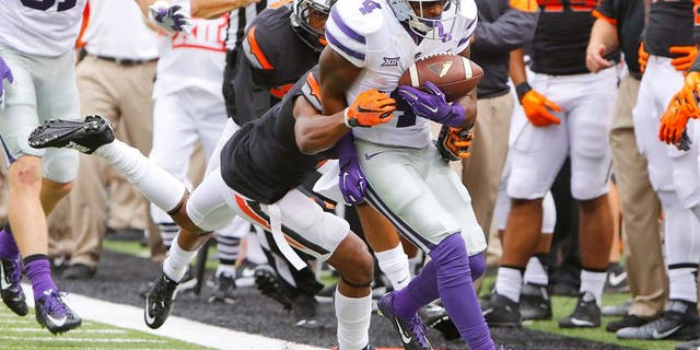 Oct 3, 2015; Stillwater, OK, USA; Kansas State Wildcats wide receiver Dominique Heath (4) is pushed out of bounds against the Oklahoma State Cowboy during the first quarter at Boone Pickens Stadium. Mandatory Credit: Alonzo Adams-USA TODAY Sports