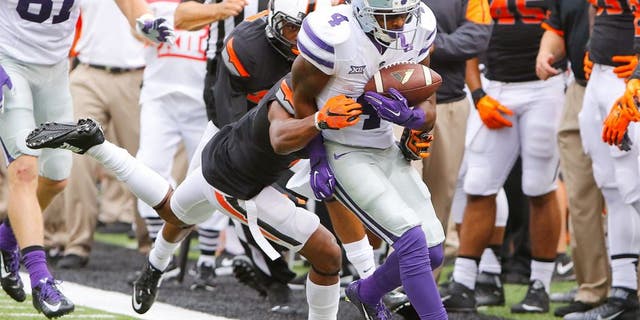 Oct 3, 2015; Stillwater, OK, USA; Kansas State Wildcats wide receiver Dominique Heath (4) is pushed out of bounds against the Oklahoma State Cowboy during the first quarter at Boone Pickens Stadium. Mandatory Credit: Alonzo Adams-USA TODAY Sports