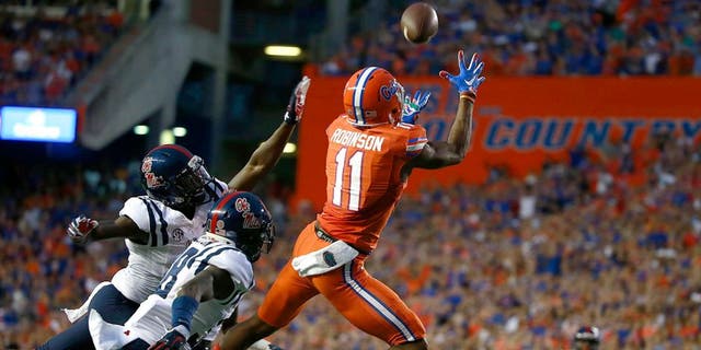 Oct 3, 2015; Gainesville, FL, USA; Florida Gators wide receiver Demarcus Robinson (11) catches the ball for a touchdown over Mississippi Rebels defensive back Mike Hilton (38) during the first quarter at Ben Hill Griffin Stadium. Mandatory Credit: Kim Klement-USA TODAY Sports