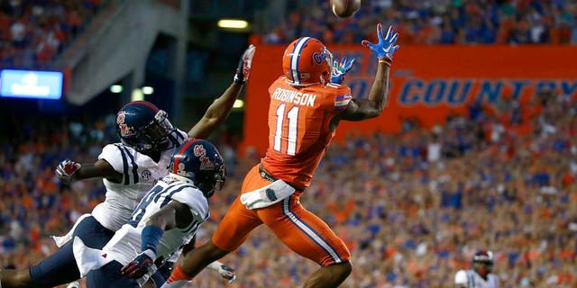 Oct 3, 2015; Gainesville, FL, USA; Florida Gators wide receiver Demarcus Robinson (11) catches the ball for a touchdown over Mississippi Rebels defensive back Mike Hilton (38) during the first quarter at Ben Hill Griffin Stadium. Mandatory Credit: Kim Klement-USA TODAY Sports