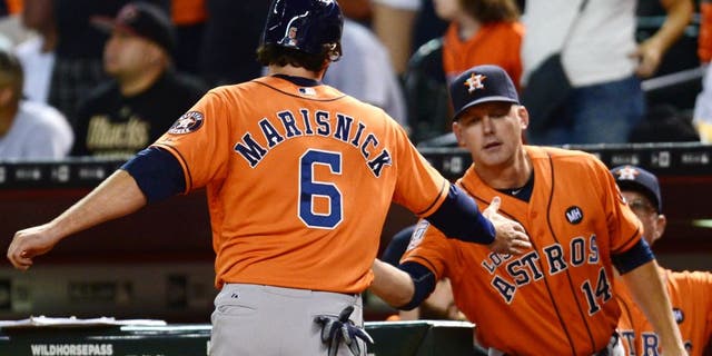 Oct 3, 2015; Phoenix, AZ, USA; Houston Astros center fielder Jake Marisnick (6) slaps hands with Houston Astros manager A.J. Hinch (14) after scoring a run in the seventh inning against the Arizona Diamondbacks at Chase Field. Mandatory Credit: Joe Camporeale-USA TODAY Sports