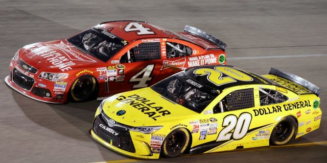 Matt Kenseth, driver of the #20 Dollar General Toyota, races Kevin Harvick, driver of the #4 Budweiser/Jimmy John's Chevrolet, during the NASCAR Sprint Cup Series Federated Auto Parts 400 at Richmond International Raceway on September 12, 2015 in Richmond, Virginia. (Photo by Jerry Markland/Getty Images)