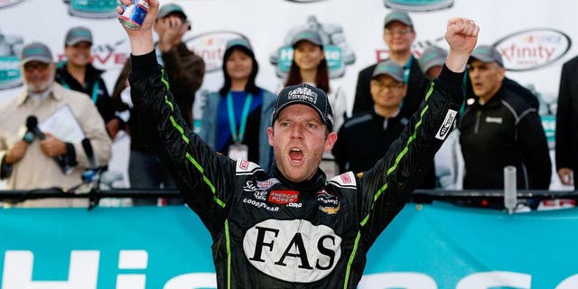 DOVER, DE - OCTOBER 03: Regan Smith, driver of the #7 Fire Alarm Services Chevrolet, celebrates in Victory LanVictory Laneafter winning the NASCAR XFINITY Series Hisense 200 at Dover International Speedway on October 3, 2015 in Dover, Delaware. (Photo by Brian Lawdermilk/Getty Images)