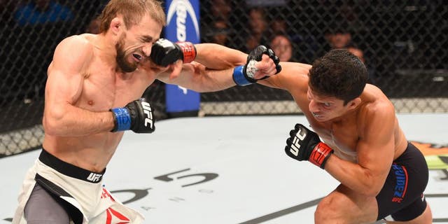HOUSTON, TX - OCTOBER 03: (R-L) Joseph Benavidez punches Ali Bagautinov in their flyweight bout during the UFC 192 event at the Toyota Center on October 3, 2015 in Houston, Texas. (Photo by Josh Hedges/Zuffa LLC/Zuffa LLC via Getty Images)