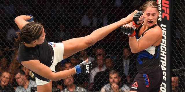 HOUSTON, TX - OCTOBER 03: (L-R) Julianna Pena kicks Jessica Eye in their women's bantamweight bout during the UFC 192 event at the Toyota Center on October 3, 2015 in Houston, Texas. (Photo by Josh Hedges/Zuffa LLC/Zuffa LLC via Getty Images)