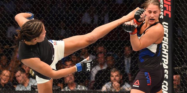 HOUSTON, TX - OCTOBER 03: (L-R) Julianna Pena kicks Jessica Eye in their women's bantamweight bout during the UFC 192 event at the Toyota Center on October 3, 2015 in Houston, Texas. (Photo by Josh Hedges/Zuffa LLC/Zuffa LLC via Getty Images)
